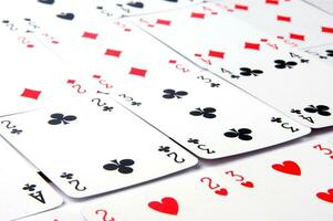 a pile of playing cards on a table photo