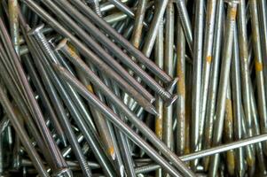 a pile of nails with a variety of sizes photo