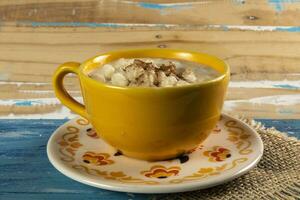 cup of canjica, typical food consumed in the Brazilian Festa Juninas photo