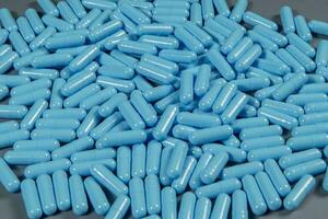 Blue antibiotic capsule pills texture. Pharmaceutical production. Global health. Resistance to antibiotic drugs photo