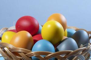 easter basket with straw and colored eggs photo