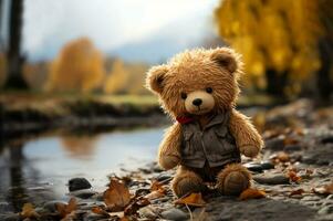 Lonely Teddy bear doll standing alone with blurry autumn forest background,Lost brown bear toy looking sad,International missing children's day,Generative Ai photo