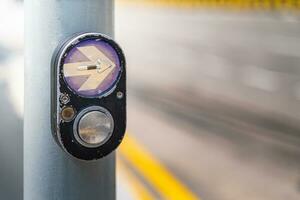 Close up button at traffic lights on pedestrian crossing photo