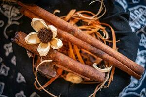 spices in wooden bowl and dried flower photo