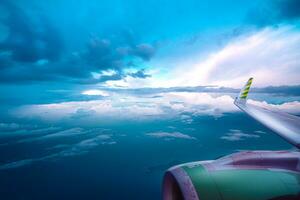 View from the airplane window on a beautiful sunset above the clouds. photo