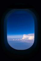 Blue sky view from airplane window with dark copy space for text photo