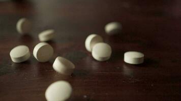 Closeup falling prescription pills, drug addiction concept video