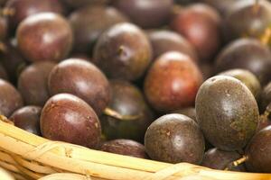 Stack of passion fruits on a market stall photo