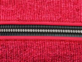 close - up of red fabric with black zipper. photo