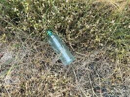 plastic trash bottle on ground. ecology concept. photo