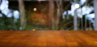 vacío oscuro de madera mesa en frente de resumen borroso bokeh antecedentes de restaurante . lata ser usado para monitor o montaje tu productos.mock arriba para espacio. foto