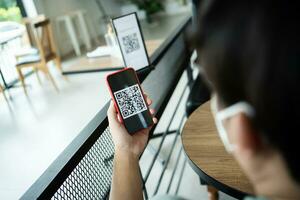 Qr code payment. E wallet. Man scanning tag accepted generate digital pay without money.scanning QR code online shopping cashless payment and verification technology concept photo