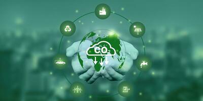 Hand holding Co2 icon on virtual screen Reduce CO2 emissions to limit global warming. Lower CO2 levels with sustainable development of renewable energy photo