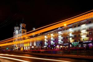 Car lights on old city background photo