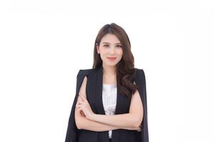 Professional young Asian confident working woman who has long hair with black suit is standing and arm crossing while working isolated on white background. photo