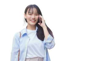 Professional business Asian female is walking to office or work place while she holds talks to customer on phone with smartphone among business building while working isolated on white background. photo