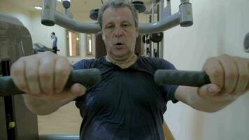 Sweaty man working out on exercise machine video