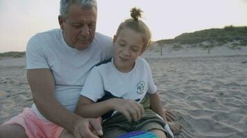 Grandfather learning modern toys with grandson video