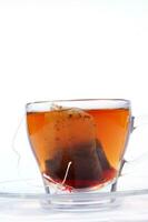 a glass cup with a tea bag in it photo