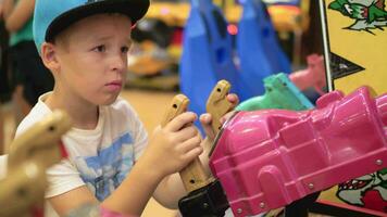 Child having fun with shooter attraction video