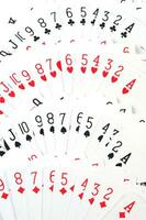 a pile of playing cards on a table photo