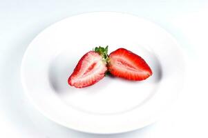 a glass bowl filled with strawberries photo