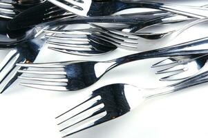 a bunch of silver forks and knives photo