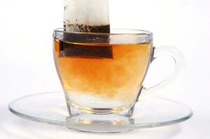 a glass cup with a tea bag in it photo