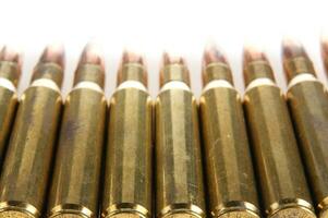 a row of bullet cartridges on a white background photo