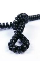 a black cord with a white background photo