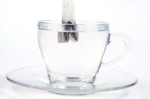 a glass cup with a tea bag in it photo