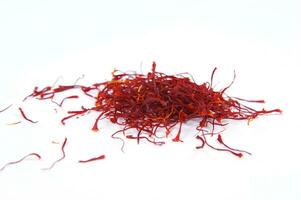 a pile of red saffron on a white background photo