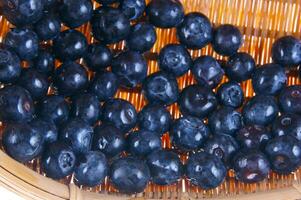 a bunch of blueberries on a wicker basket photo