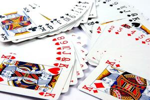 a pile of playing cards on a table photo