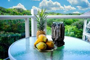 An arrangement of Hawaiian fruit on a patio table outside in Maui, Hawaii. photo