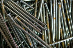 a pile of nails with a variety of sizes photo