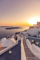 Amazing evening view of Fira, caldera, volcano of Santorini, Greece with cruise ships at sunset. Cloudy dramatic sky landscape, vertical panoramic banner. Beautiful summer sunset vacation scenery photo