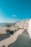 Amazing evening view of Fira, caldera, volcano of Santorini, Greece with cruise ships at sunset. Cloudy dramatic sky landscape, vertical panoramic banner. Beautiful summer sunset vacation scenery photo