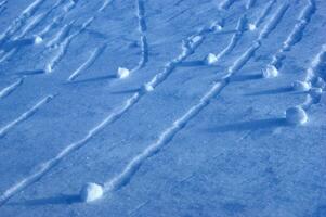 a snowboarder is riding down a slope photo