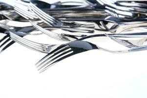 a bunch of silver forks and knives photo