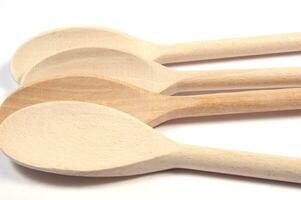 a group of wooden spoons sitting on a white surface photo