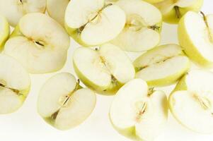 a bunch of apples cut in half photo