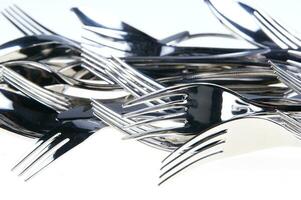 a bunch of silver forks and knives photo