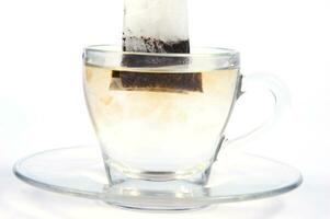 a glass cup with a tea bag in it photo