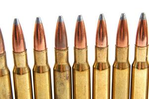 a row of bullet cartridges on a white background photo