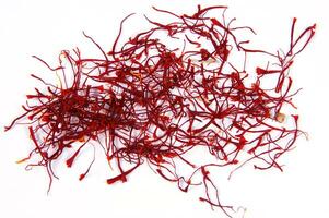 a pile of red saffron on a white background photo