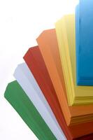 a stack of colored paper with a white background photo