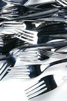 a bunch of silver forks and knives photo