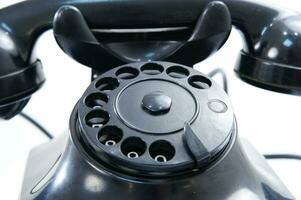 a black telephone on a white background photo