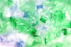 plastic bottles are scattered on a white surface photo